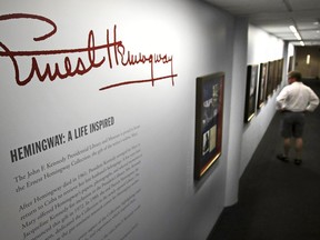 A visitor views the "Ernest Hemingway: A Life Inspired" exhibition, featuring books and belongings from the archives of author Hemingway, at the John F. Kennedy Presidential Library and Museum in Boston, Thursday, June 28, 2018. The Boston complex has become the world's leading research center for Hemingway studies.