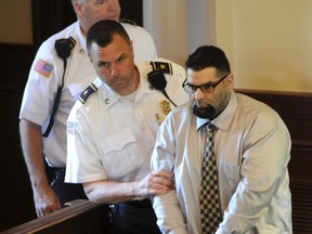 This photo taken June 8, 2018, shows Christopher Fratantonio, 37, being led into Barnstable Superior Court in Barnstable, Mass. Fratantonio received the mandatory sentence of life without parole following his first-degree murder conviction Friday in the February 2017 killing of 35-year-old Mary Fratantonio inside their Barnstable home.c