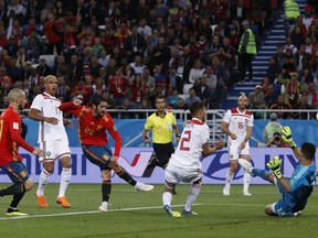 Spain's Isco, 3rd left, scores his side's opening goal during the group B match between Spain and Morocco at the 2018 soccer World Cup at the Kaliningrad Stadium in Kaliningrad, Russia, Monday, June 25, 2018.