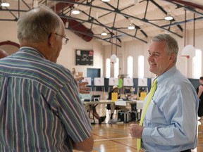 David Trone, candidate for U.S. House of Representatives in the Maryland 6th District, talks with election judges in the William R. Talley Recreation Center polling location Tuesday, June 26, 2018,  in Frederick, Md.