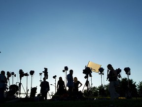 TV crews waiting for a news conference line up at the side of the road across the newspaper office building where multiple people were shot this afternoon inside of the newsroom, in Annapolis, Md., Thursday, June 28, 2018.