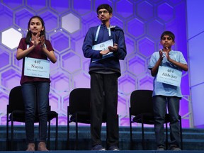 The final three competitors in the Scripps National Spelling Bee, from left, Naysa Modi, 12, from Frisco, Texas, Karthik Nemmani, 14, from McKinney, Texas, and Abhijay Kodali, 11, from Flower Mound, Texas, applaud during the bee in Oxon Hill, Md., Thursday, May 31, 2018. They placed second, first, and third, respectively.