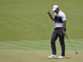 Tiger Woods holds up his ball on the seventh green during the third round of the Quicken Loans National golf tournament, Saturday, June 30, 2018, in Potomac, Md.