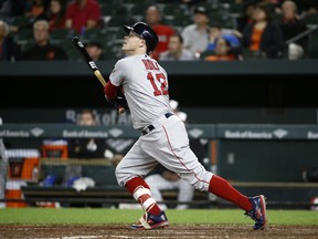 Boston Red Sox's Brock Holt watches his sacrifice fly ball in the 12th inning of a baseball game against the Baltimore Orioles, Monday, June 11, 2018, in Baltimore. Xander Bogaerts scored on the play. Boston won 2-0 in 12 innings.