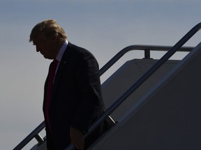 President Donald Trump walks down the steps of Air Force One at Duluth International Airport, in Duluth, Minn., Wednesday, June 20, 2018. Trump is in Duluth to speak at a rally for Pete Stauber, a Republican congressional candidate running in a traditionally Democratic district.