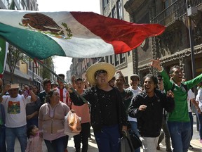 Mexico fans in Mexico City celebrate their team's progression to the round of 16 at the World Cup on June 27.