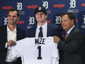 Detroit Tigers first overall pick Casey Mize, center, stands with Tigers scout Justin Henry, left, and Scott Pleis, director of amateur scouting, during a news conference where he was introduced to the media, Monday, June 25, 2018, in Detroit.