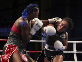 Claressa Shields, left, throws a punch at Hanna Gabriels, of Costa Rica, during the 10th round of their IBF and WBA women's middleweight championship boxing bout, early Saturday, June 23, 2018, in Detroit. Shields won the bout by decision.
