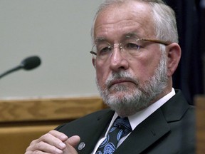 Former Michigan State University dean William Strampel watches the court proceedings at his preliminary exam in East Lansing, Mich., Tuesday, June 5, 2018. The former dean of the College of Osteopathic Medicine is charged with failing to properly supervise former sports doctor Larry Nassar, who sexually assaulted women and girls while working at Michigan State.