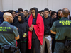 Guardia Civil officers stand guard as migrants gather at an emergency centre in Barbate, Spain, after being rescued by in the Strait of Gibraltar, June 28, 2018.