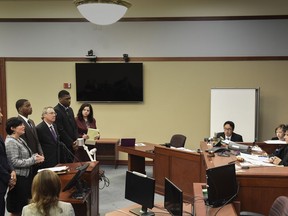 Defense attorney Mary Chartier, second from left, speaks on behalf of her client Demetric Vance, left, Donnie Corley, third from left, and Josh King, fifth from left, during their sentencing hearing in Ingham County Circuit Court, Wednesday, June 6, 2018, in Lansing, Mich. The three former Michigan State University football players previously pleaded guilty to reduced charges in the 2017 sexual assault of a woman in an apartment bathroom. Also pictured are attorneys John Shea, fourth from left,, and Shannon Smith, sixth from left. Judge Rosemarie Aquilina presides at right.