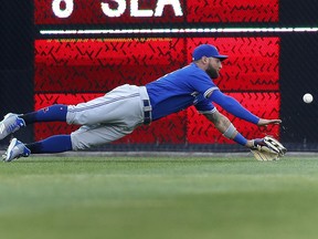 Toronto Blue Jays center fielder Kevin Pillar dives but can't reach a Detroit Tigers' JaCoby Jones two-run triple in the second inning of a baseball game in Detroit, Friday, June 1, 2018.