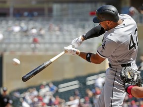 Chicago White Sox Yoan Moncada hits a solo home run against the Minnesota Twins in the first inning in game 1 of a doubleheader baseball game Tuesday, June 5, 2018, in Minneapolis. As a makeup game from Jackie Robinson Day, all players and coaches wear 42.