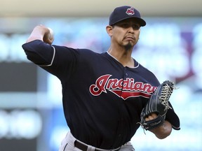 Cleveland Indians pitcher Carlos Carrasco throws to a Minnesota Twins batter during the first inning of a baseball game Friday, June 1, 2018, in Minneapolis.