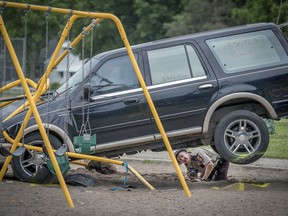 Minnesota State Patrol investigates the scene where a motorist being pursued by the State Patrol veered into a Minneapolis school playground Monday, June 11, 2018. At least two young children suffered life-threatening injuries after police say a motorist being pursued by the State Patrol veered into a Minneapolis park and struck them. The State Patrol says the driver ran from the crash scene and was arrested.