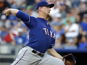 Texas Rangers starting pitcher Austin Bibens-Dirkx throws during the first inning of the team's baseball game against the Kansas City Royals on Wednesday, June 20, 2018, in Kansas City, Mo.