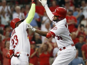 St. Louis Cardinals' Jose Martinez, right, is congratulated by teammate Marcell Ozuna after hitting a two-run home run during the third inning of a baseball game against the San Diego Padres Monday, June 11, 2018, in St. Louis.