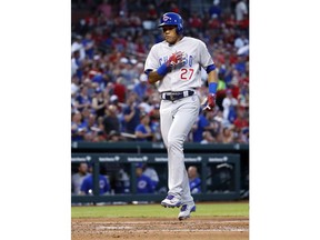 Chicago Cubs' Addison Russell scores after hitting a solo home run during the fourth inning of a baseball game against the St. Louis Cardinals Saturday, June 16, 2018, in St. Louis.