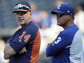 Houston Astros manager AJ Hinch (14) looks over his shoulder while talking with Kansas City Royals manager Ned Yost before a baseball game at Kauffman Stadium in Kansas City, Mo., Friday, June 15, 2018.