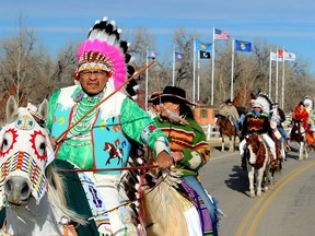 In this Dec. 3, 2012 file photo, Darrin Old Coyote, then chairman of the Crow Indian tribe, leads riders past Veterans Park as members gather for the inaugural parade in Crow Agency, Mont.