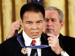 President George W. Bush presents the Presidential Medal of Freedom to Muhammad Ali in November 2009. President Donald Trump said he is thinking "very seriously" about pardoning Ali for his conviction on draft evasion, even though the Supreme Court overturned the boxing champion's conviction in 1971.