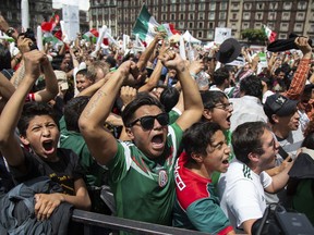 Fan's celebrate Mexico's win during the Mexico vs. Germany World Cup soccer match, as they watched it on an outdoor screen in Mexico City's Zocalo, Sunday, June 17, 2018. Mexico won it's first match against Germany 1-0.