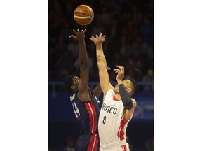 Mexico's Gustavo Ayon, right, jumps for the ball with U.S. player Smile Jefferson during the first quarter of a FIBA basketball World Cup qualifier in Mexico City, Thursday, June 28, 2018.