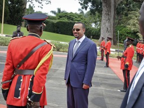Ethiopia's new Prime Minister Abiy Ahmed, 42, who was installed in April, inspects the honor guard as he arrives to meet for bilateral talks with Uganda's President Yoweri Museveni at State House in Entebbe, Uganda Friday, June 8, 2018. Sweeping changes that seemed unthinkable just weeks ago have been announced almost daily since Ahmed, Africa's youngest head of government, took office and vowed to bring months of deadly protests to an end.