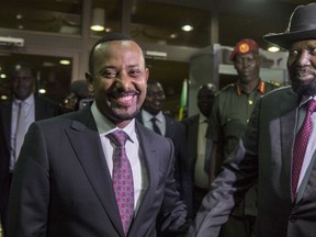 FILE - In this Wednesday, June 20, 2018, file photo, Ethiopia's Prime Minister Abiy Ahmed, left, greets South Sudan's President Salva Kiir, right, at his office in Addis Ababa, Ethiopia. An explosion disrupted a huge rally for Ahmed on Saturday, June 23, 2018, shortly after he spoke and was waving to the crowd that had turned out in numbers unseen in recent years in the East African nation.
