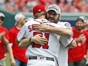 Washington Capitals' Alex Ovechkin, from Russia, right, hugs Washington Nationals' Max Scherzer after throwing out two ceremonial first pitches before a baseball game between the Washington Nationals and the San Francisco Giants at Nationals Park, Saturday, June 9, 2018, in Washington.