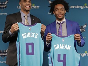 Charlotte Hornets draft picks Miles Bridges, left, and Devonte' Graham pose for a photo during a news conference for the NBA basketball team in Charlotte, N.C., Friday, June 22, 2018.