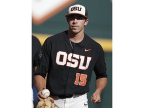 Oregon State pitcher Luke Heimlich (15) walks on the field before Game 1 of the NCAA College World Series baseball finals against Arkansas in Omaha, Neb., Tuesday, June 26, 2018.