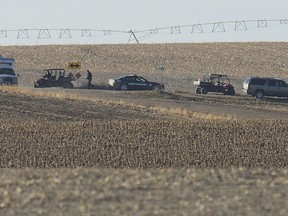 In this photo taken Dec. 5, 2017, law enforcement personnel examine a stretch of road near Clay Center, Neb., as they search for the remains of Sydney Loofe who had been missing since Nov. 16, 2017. Prosecutors allege in court documents unsealed Tuesday, June 12, 2018, that Aubrey Trail told investigators that he strangled 24-year-old Loofe, of Lincoln, with an extension cord on Nov. 15 2017. Her dismembered body parts were found in trash bags dumped in a field. Trail and Bailey Boswell face murder and other charges.