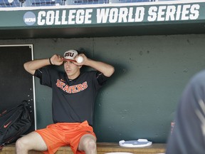 Oregon State pitcher Luke Heimlich sits in the dugout before practice at TD Ameritrade Park in Omaha, Neb., Friday, June 15, 2018. Oregon State plays North Carolina on Saturday in the NCAA College World Series baseball tournament..
