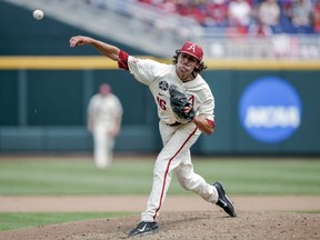 Arkansas pitcher Blaine Knight (16) delivers against Texas in the fifth inning of an NCAA College World Series baseball game in Omaha, Neb., Sunday, June 17, 2018.