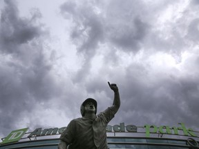 Heavy clouds cover the sky above TD Ameritrade Park and The Road to Omaha statue, during a weather delay in the NCAA College World Series baseball elimination game between Oregon State and Washington, in Omaha, Neb., Monday, June 18, 2018.