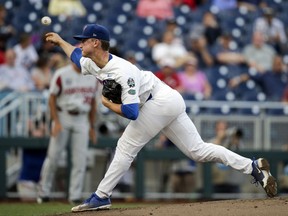 Florida pitcher Brady Singer throws against Arkansas in the first inning of an NCAA College World Series baseball game in Omaha, Neb., Friday, June 22, 2018.
