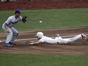 Texas' Duke Ellis, right, beats the throw to Florida third baseman Jonathan India (6) in the first inning of an NCAA College World Series baseball elimination game in Omaha, Neb., Tuesday, June 19, 2018.