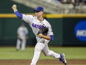 Florida pitcher Brady Singer (51) delivers against Texas Tech in the third inning of an NCAA College World Series baseball game in Omaha, Neb., Sunday, June 17, 2018.