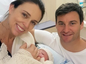In this photo released by the Office of the Prime Minister of New Zealand, Prime Minster Jacinda Ardern and her partner Clarke Gayford pose with their newborn daughter at the Auckland City Hospital, Thursday, June 21, 2018, in Auckland, New Zealand.