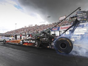 In this photo provided by the NHRA, Clay Millican does a burnout during Top Fuel qualifying Saturday, June 23, 2018, at the 12th annual Summit Racing Equipment NHRA Nationals drag races in Norwalk, Ohio. Millican used a 3.750-second pass at a track record 332.67 mph in the lone qualifying session of the day.
