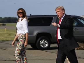 President Donald Trump, first lady Melania Trump and their son Barron Trump, walk on the tarmac upon arrival at Morristown Municipal Airport, in Morristown, N.J., Friday, June 29, 2018.