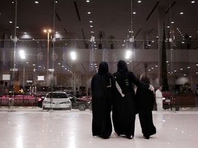 In this June 21, 2018 photo, women leave after looking at cars at the Al-Jazirah Ford showroom in Riyadh, Saudi Arabia. The lifting of the ban on women driving marks a milestone for women in the kingdom who have had to rely on drivers, male relatives, taxis and ride-hailing services to get to work, go shopping and simply move around.