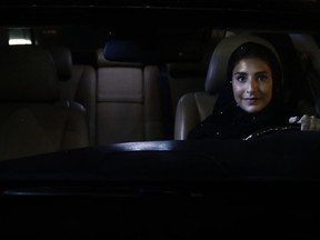 Hessah al-Ajaji sits in her car on the capital's busy Tahlia Street after driving for the first time in Riyadh, Saudi Arabia, Sunday, June 24, 2018. Saudi women are in the driver's seat for the first time in their country and steering their way through busy city streets just minutes after the world's last remaining ban on women driving was lifted on Sunday.