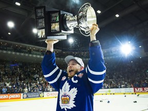 Toronto Marlies right wing Ben Smith (18) hoists the AHL Calder Cup after defeating the Texas Stars in Toronto on Thursday, June 14, 2018.