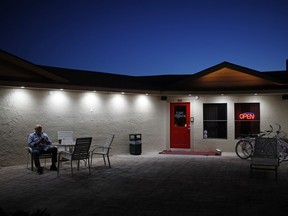 In this April 27, 2018, photo, owner Dennis Hof sits in front of the Love Ranch brothel in Crystal, Nev. A coalition of religious groups and anti-sex trafficking activists have launched referendums to ban brothels in two of Nevada's seven counties where they legally operate. Hof, who has half a dozen brothels operating in the two counties and starred in the HBO adult reality series "Cathouse," is challenging incumbent Assembly member James Oscarson of Pahrump in a Republican primary Tuesday, June 12.