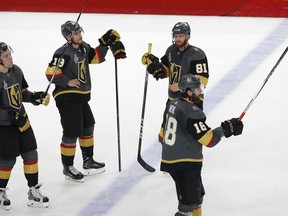 Vegas Golden Knights' David Perron (57), Reilly Smith (19), Jonathan Marchessault (81) and James Neal (18) watch the Washington Capitals celebrate after the Capitals defeated the Golden Knights in Game 5 of the NHL hockey Stanley Cup Finals Thursday, June 7, 2018, in Las Vegas.