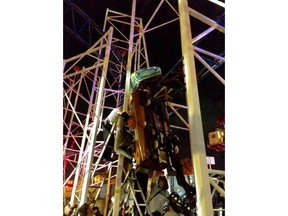 This photo provided by the Daytona Beach Fire department shows emergency crews working on a roller coaster car that derailed at the Daytona Beach Boardwalk on  Thursday, June 14, 2018 in Daytona Beach, Fla.  Two passengers fell 34 feet (10 meters) to the ground and authorities had to pull eight others to safety.  The accident is under investigation according Daytona Beach Fire spokeswoman Sasha Staton.   (Daytona Beach Fire department  via AP)