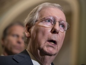 FILE - In this May 15, 2018 file photo, Senate Majority Leader Mitch McConnell, R-Ky., speaks to reporters following a closed-door luncheon with President Donald Trump, at the Capitol in Washington. McConnell warns that key Kentucky products including bourbon could wind up targets of retaliation if a trade war erupts. The growing trade dispute stems from the Trump administration's decision to impose tariffs on steel and aluminum from Europe, Mexico and Canada. McConnell said Kentucky-made bourbon, farm products and automobiles could be hurt from retaliatory moves.