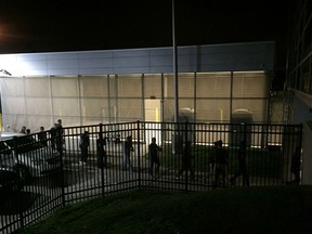 In this image provided by Jodie Bowers, detainees are escorted into an Immigration and Customs Enforcement (ICE) facility, early Wednesday, June 20, 2018, in Brooklyn Heights, Ohio. More than 100 workers were arrested Tuesday, at an Ohio meatpacking plant by federal agents following a yearlong immigration investigation, the second large-scale raid within the state in the past two weeks.